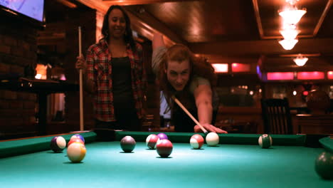 couple playing snooker in night club 4k