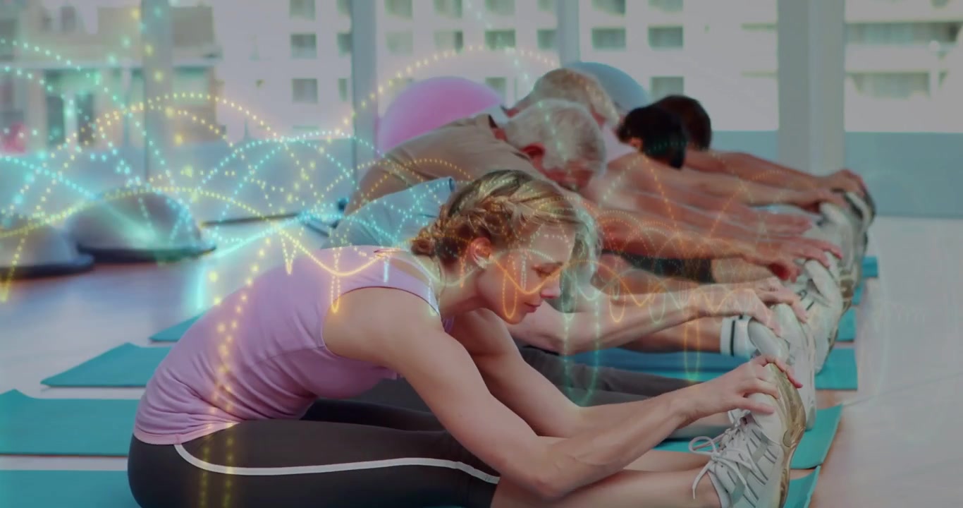 Front-left woman initiating forward bend, fitness class following toe touches, DNA overlay moving