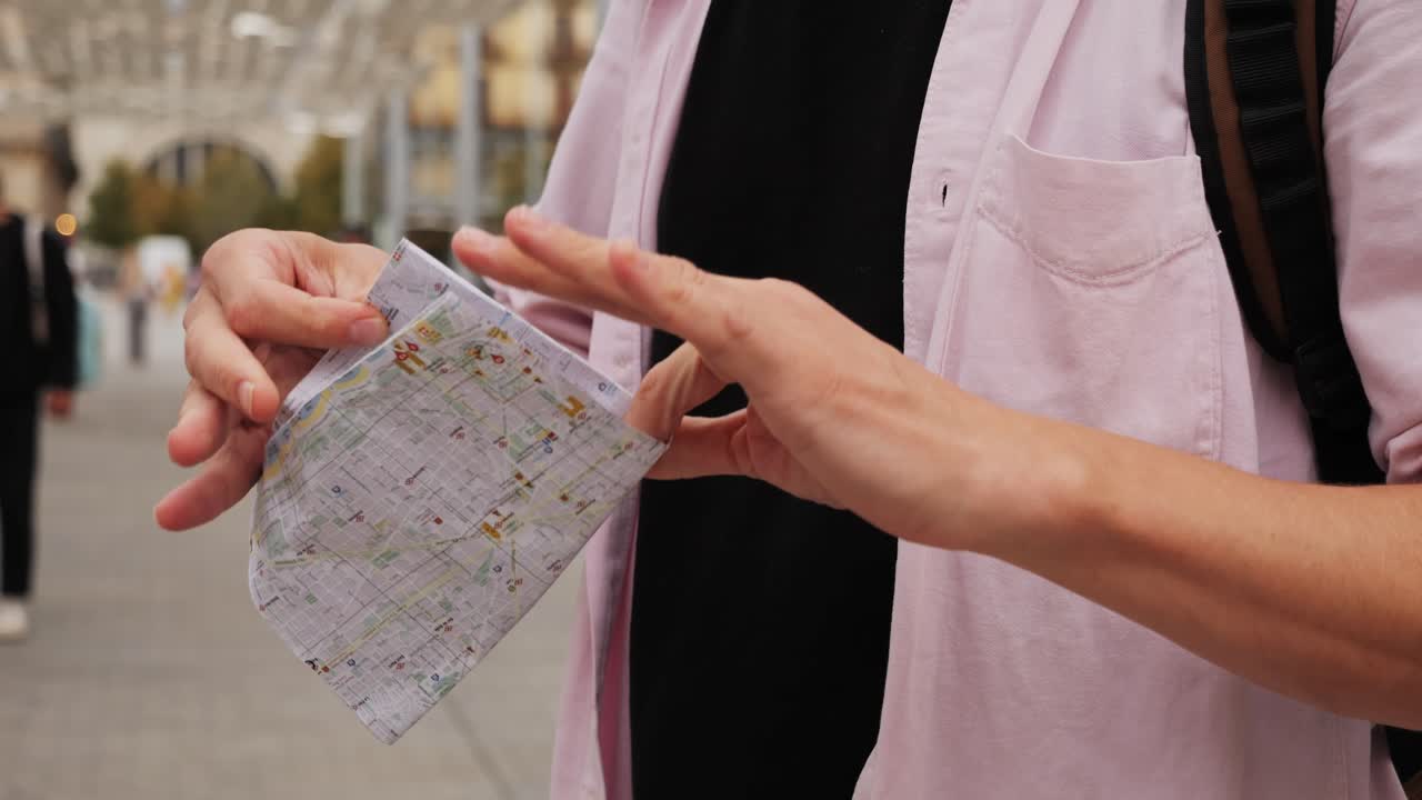 Man tourist using smart phone searching location in map application online close up macro. Backpacker using GPS to find destination on vacation. City or Forest hiking, walking in europe