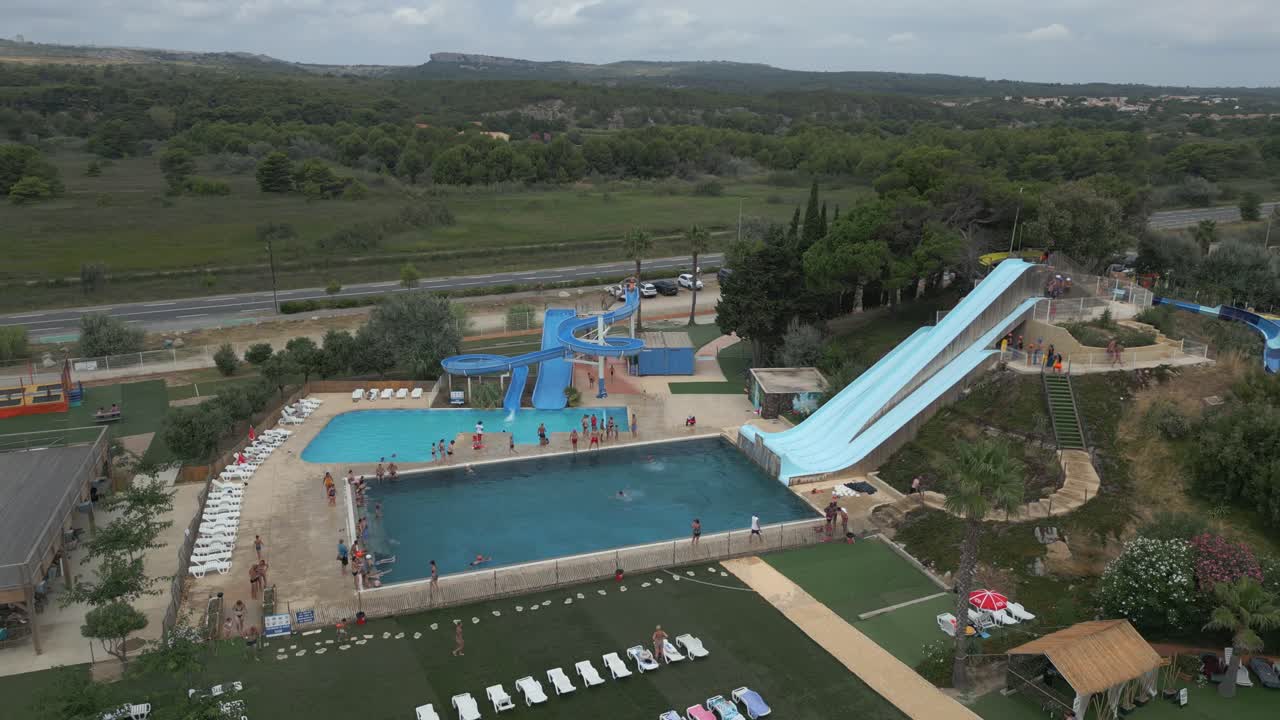 Families and friends enjoying a sunny summer day at a vibrant water park, sliding down thrilling waterslides and creating joyful memories filled with laughter and excitement