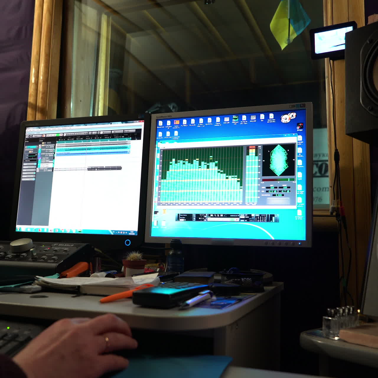 Sound engineer working at mixing panel in boutique recording studio. Close-up