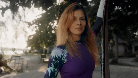 woman in a purple rash guard at the beach
