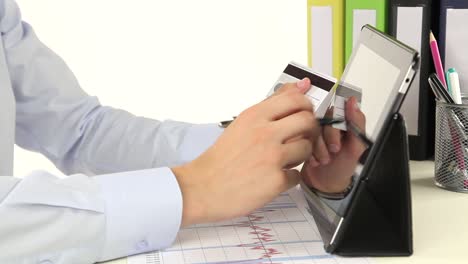 person using a tablet to make online payment using credit card.