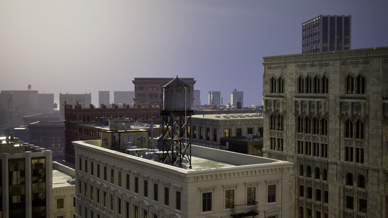 Urban skyline at dusk featuring historic architecture and a water tower