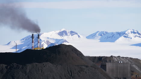 A-coal-power-plant-pollutes-the-air-with-smoke-in-front-of-glacier-in-Arctic