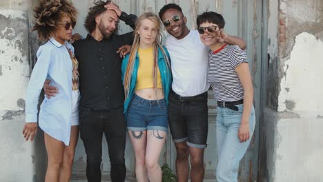 young happy friends posing on street