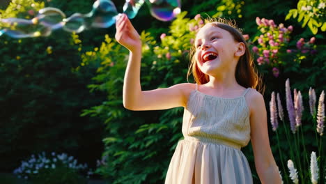 happy girl playing with bubbles in a garden
