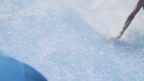 boy riding wave machine on boogie board