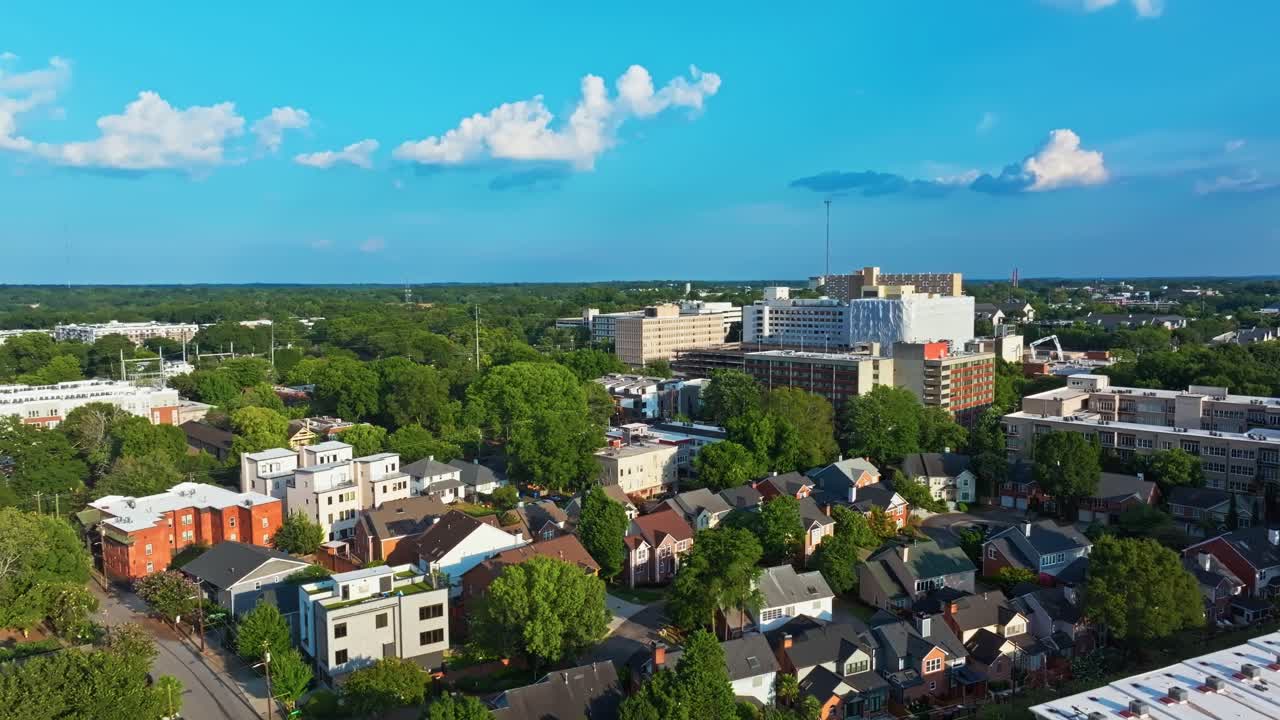 Atlanta housing neighbourhood surrounded by green trees, garden, urban park under clear blue sky, Georgia, Aerial
