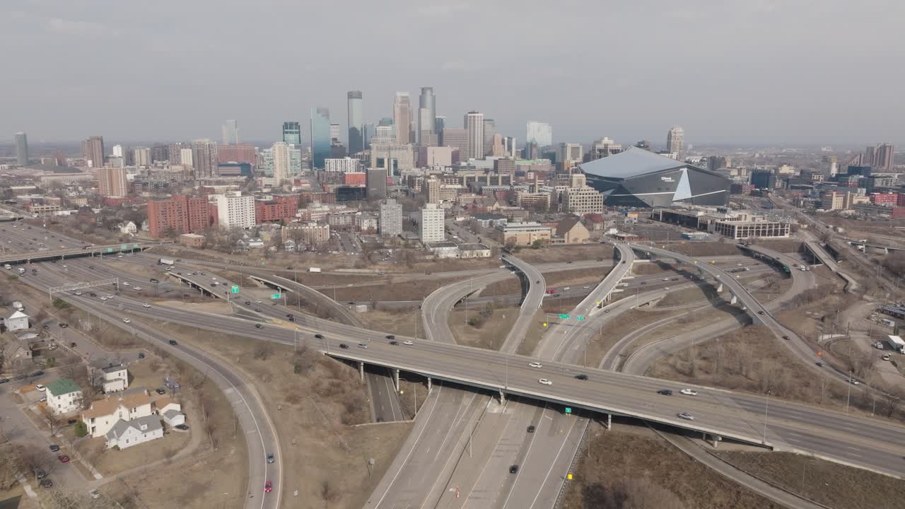 Drone flyover of 35W I-94 interchange with downtown Minneapolis and stadium view.