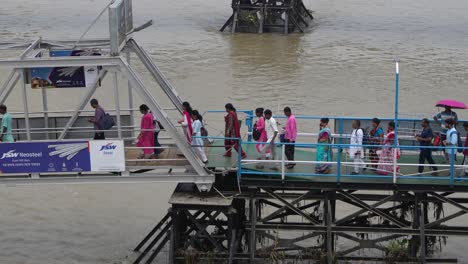 people are boarding the ship from the wharf.