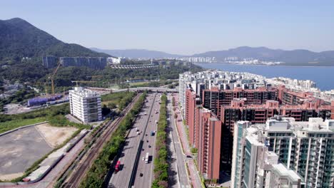 tall colored condominiums in science park and residential area partly under construction next to the highway