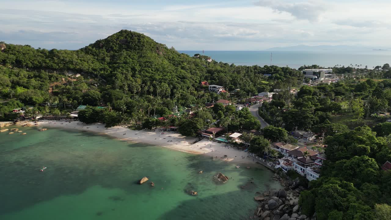 Zoom out aerial footage of densely vegetated island groups of Koh Samui with clear waters