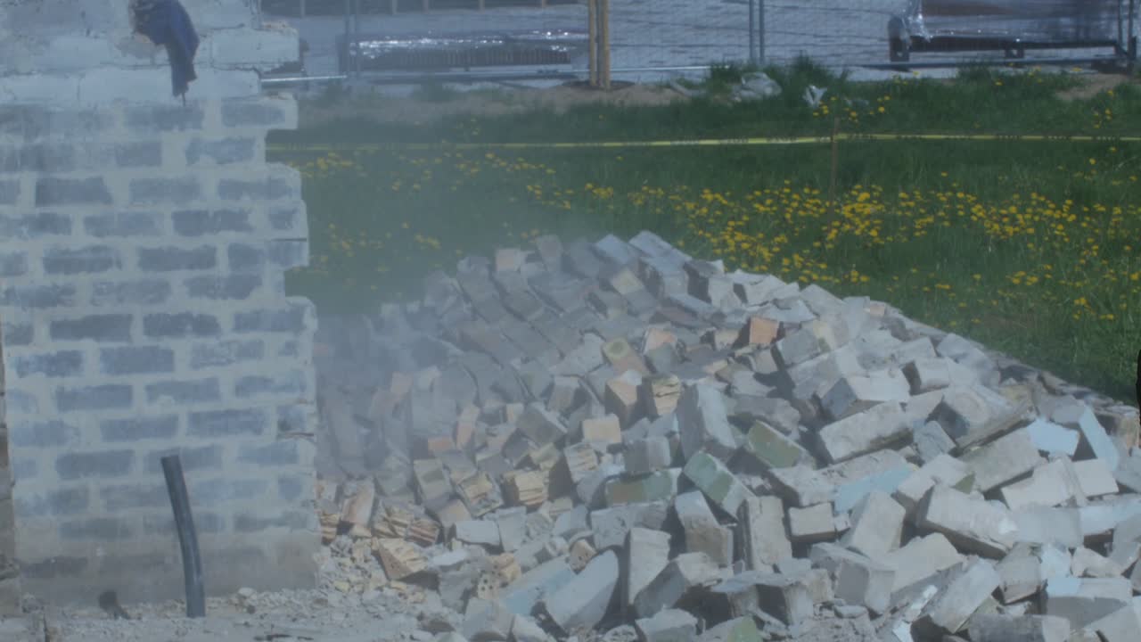 White Brick Wall Collapses During Demolition Of An Old Building