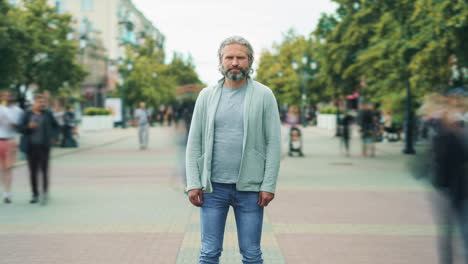 man standing on city street