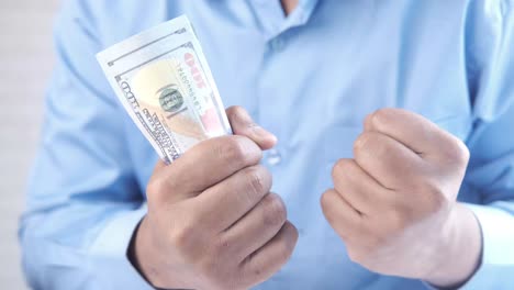 man holding money with clenched fists