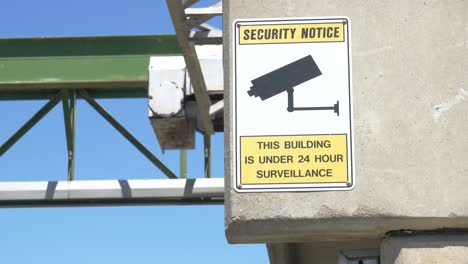 under surveillance sign hung outside warehouse to protect employees