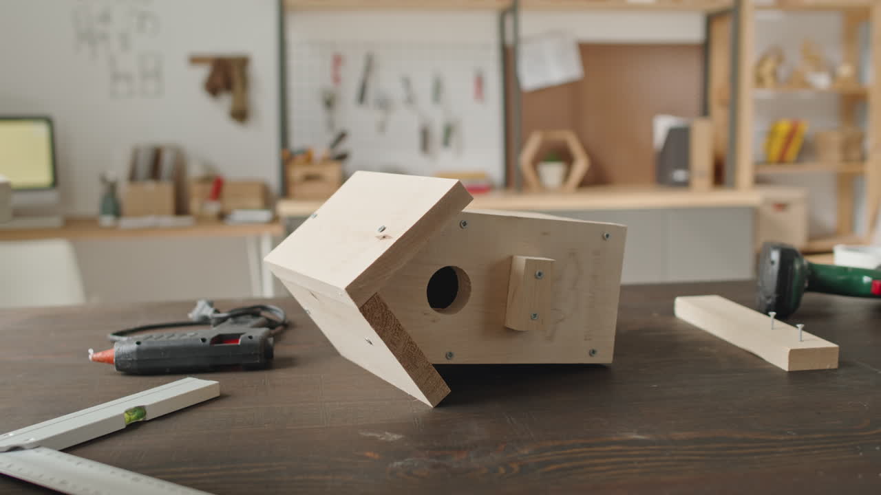 A wooden birdhouse project in a workshop setting