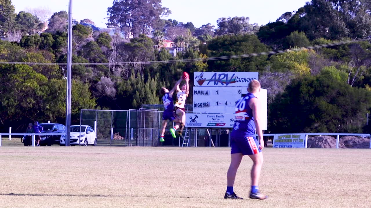 Australian rules football of a player marking the ball and kicking.