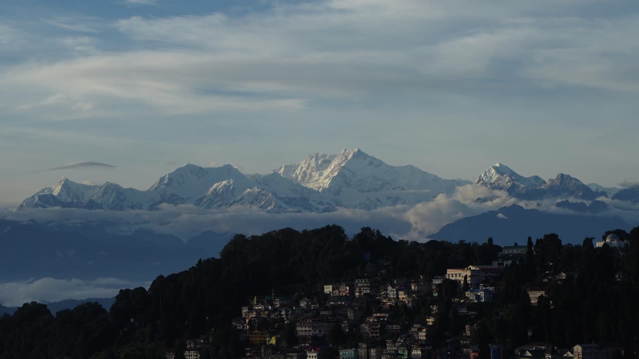 The first morning light of the sun has arrived on the distant horizon of Mount Kanchenjunga