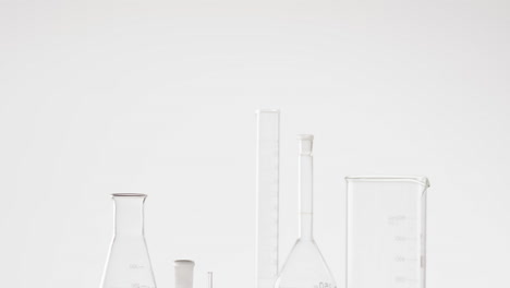 video of glass laboratory beakers and dishes with copy space on white background