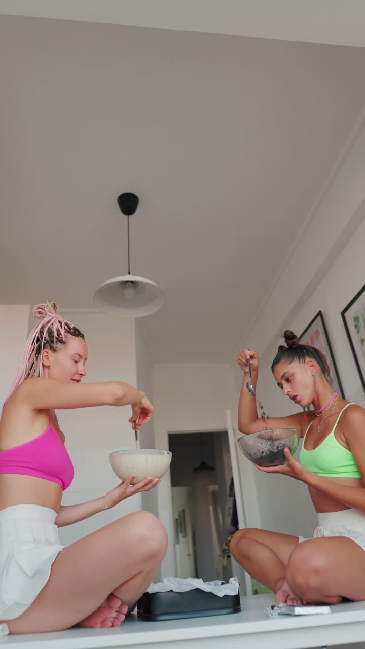 Two women cooking indoors