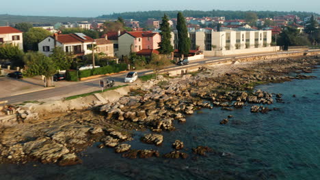 Aerial-tracking-shot-of-car-driving-along-the-coast-road-of-Savudrjia-Istria-Croatia