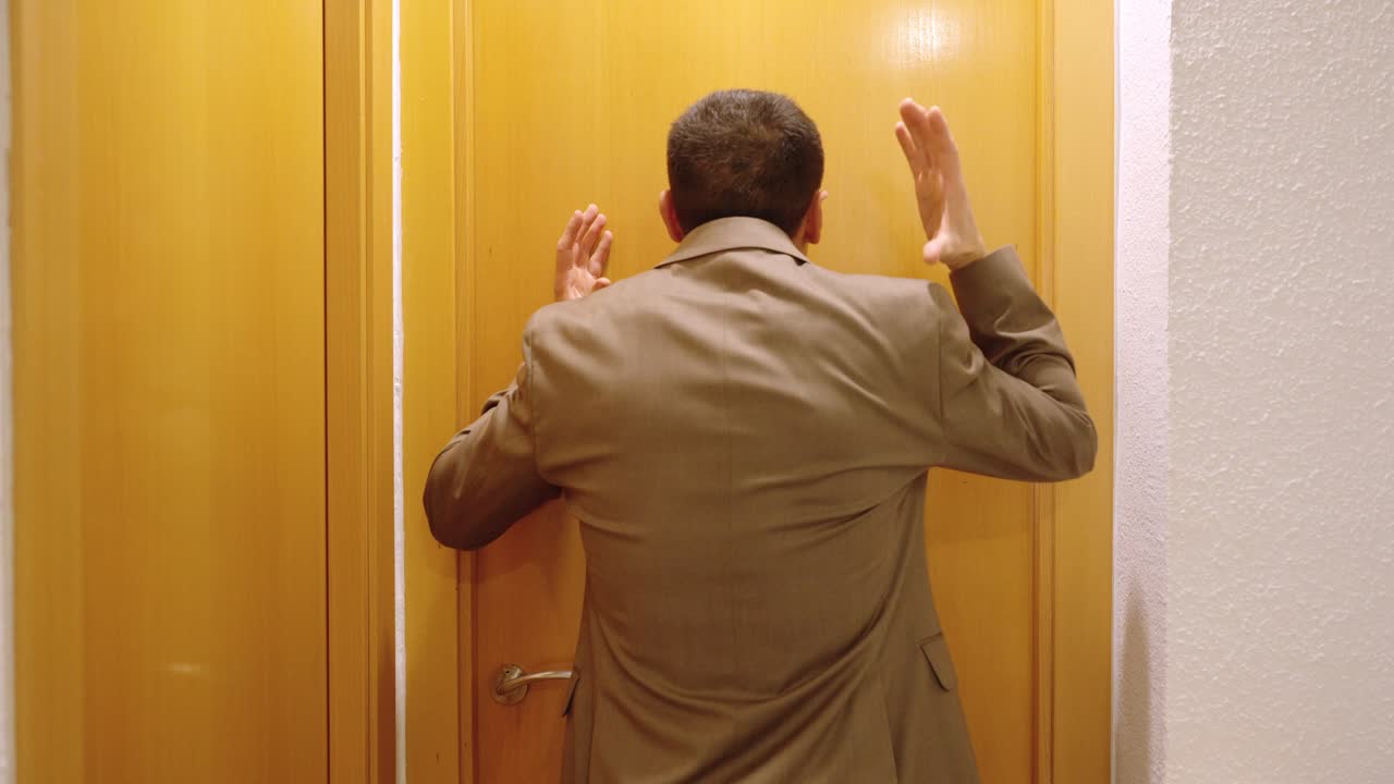 Angry man waiting for wife in front of door