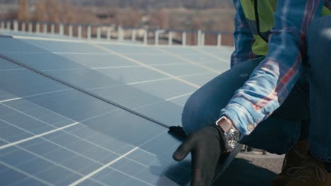 solar panel technician inspecting panels on rooftop