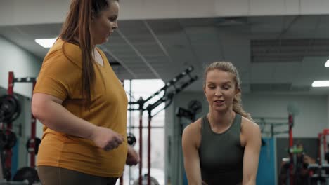 Caucasian-female-trainer-showing-how-to-make-a-exercises-with-rope-at-the-gym-.