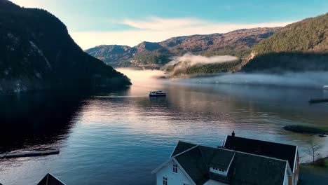 serene fjord landscape with fog and boat