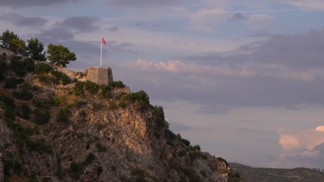 the famous albanian flag on in distance from ancient castle during sunset