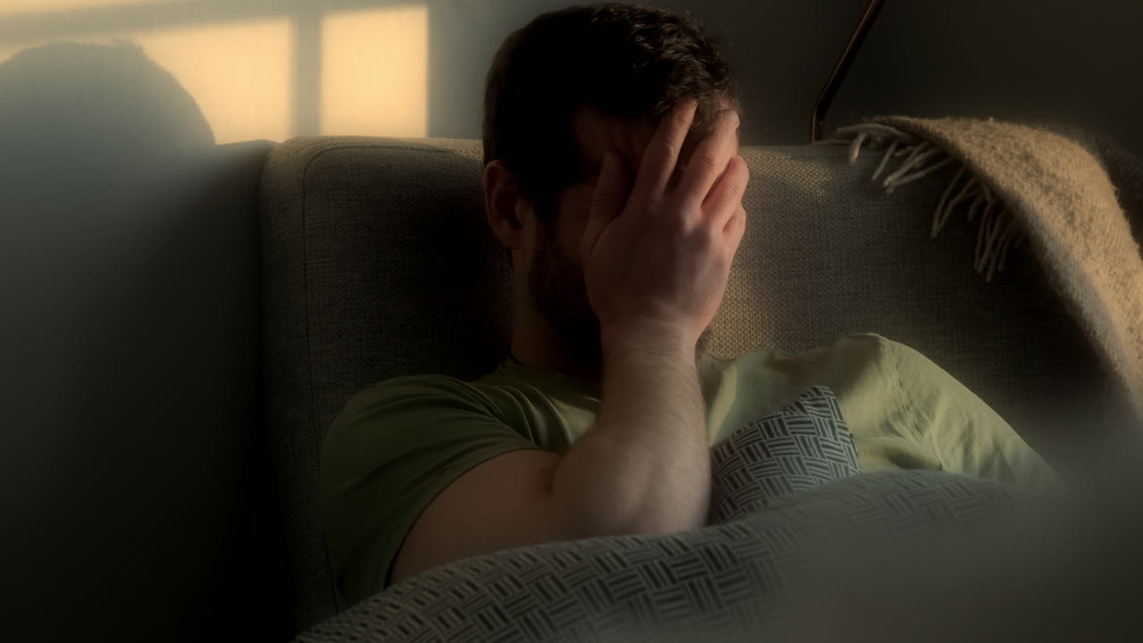 crying white caucaian man, close face shot, soft golden light