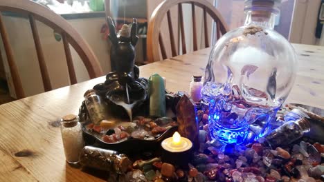 Collection-of-colourful-healing-crystals-and-mysterious-spiritual-skull-on-wooden-kitchen-table