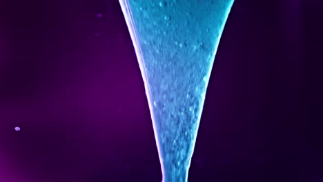 vibrant liquids swirl and mix in a colorful macro shot with a glowing purple and blue gradient backdrop