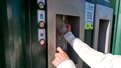 person filling bottle from water dispenser