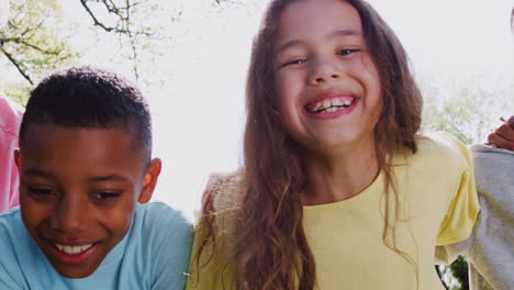 portrait of smiling children outdoors at home looking into camera