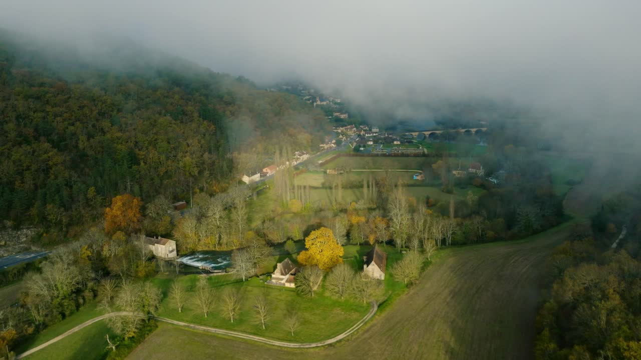 Drone through a layer of fog and discover a French village