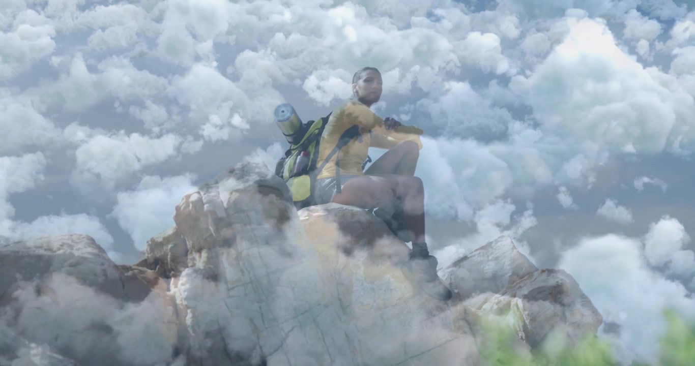 Climbing highest ledge, hiker initiating cloud overlay, gazing horizon for reflection in travel