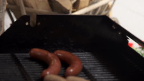 Grilling-sausages-with-wood-fire-by-the-roadside