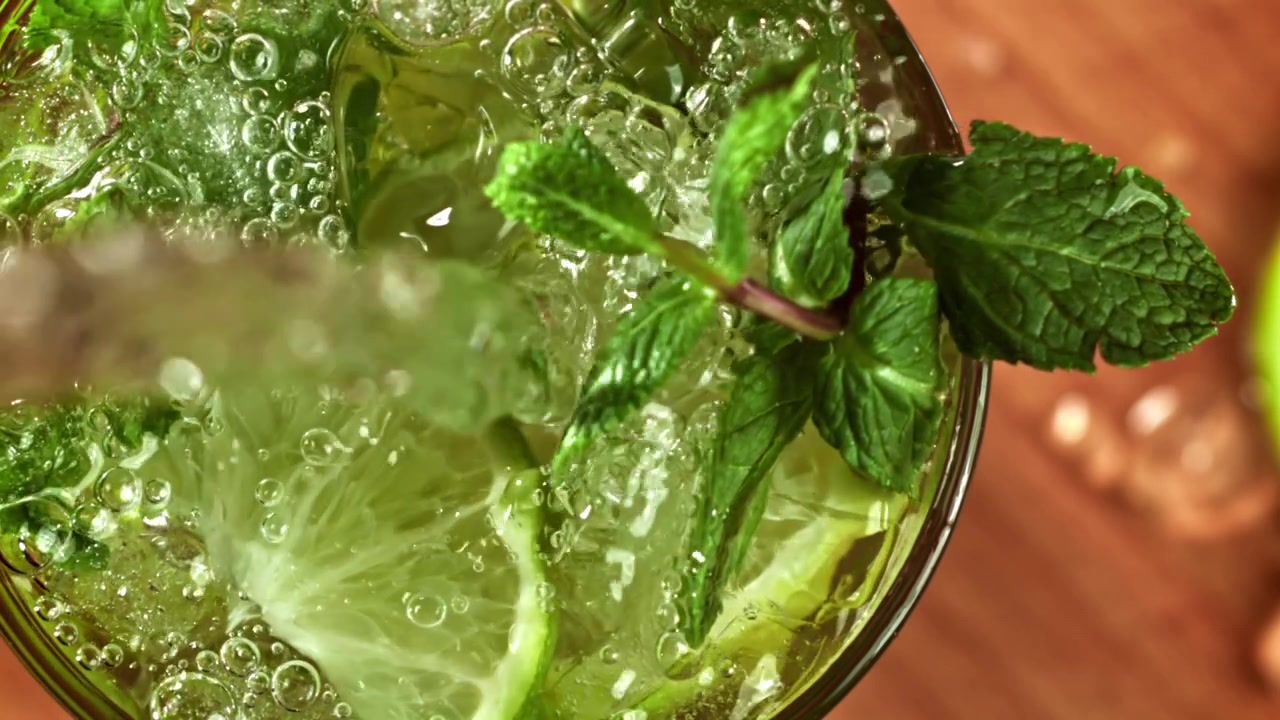 Versamento di un cocktail Mojito rinfrescante con lime e menta