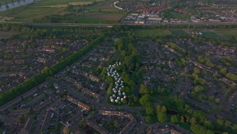 Reveal-shot-of-The-Bolwoningen-'s-Hertogenbosch-with-soft-light,-aerial