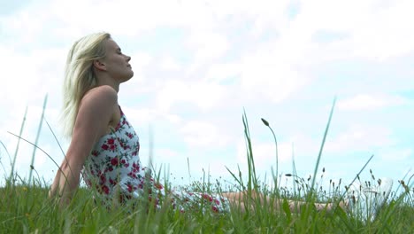 Una-Dama-Sentada-Sola-En-La-Hierba-Disfrutando-Del-Viento-Y-El-Sol-Con-Comodidad