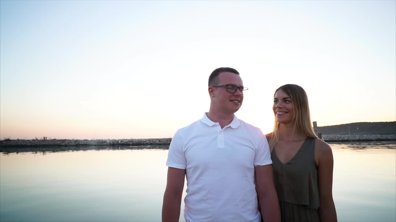 Couple enjoying a sunset by the water