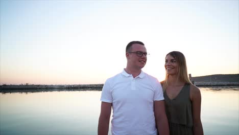 couple enjoying a sunset by the water