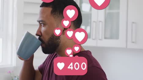 animación de números y iconos de corazones en las redes sociales sobre un hombre biracial bebiendo café
