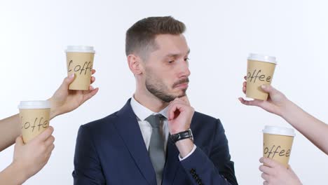 handing four cups of coffee to businessman