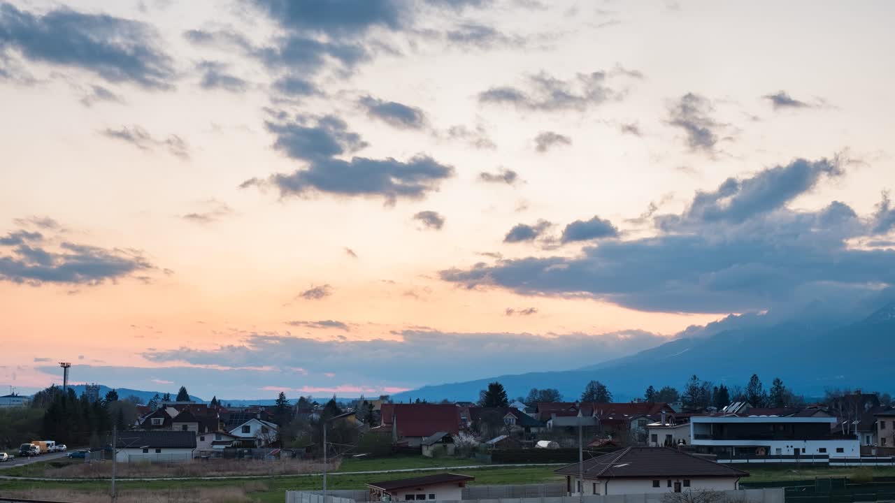 4K Timelapse of sunset over Poprad, Slovakia, from train station viewpoint. Scenic rooftops, pastel sky, and distant mountains—ideal for travel, landscape, and urban footage
