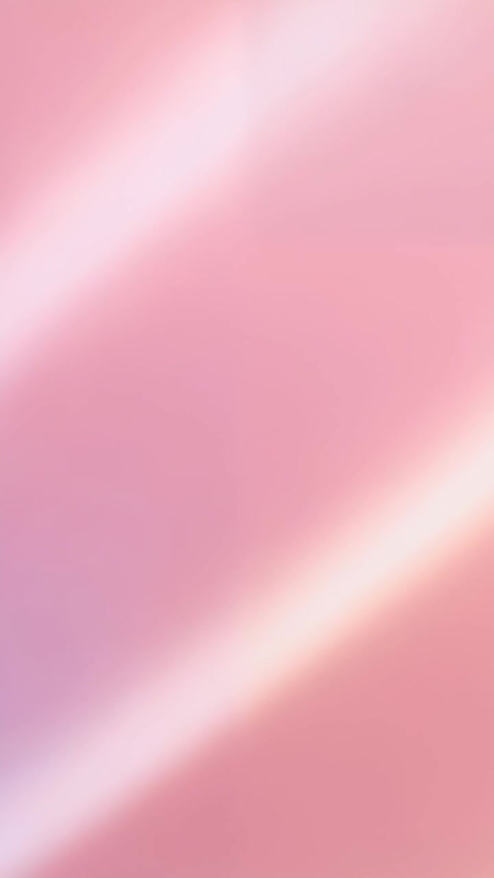 Vertical video: Shifting camera showing blurry pink field closeup, focus shift making diagonal band