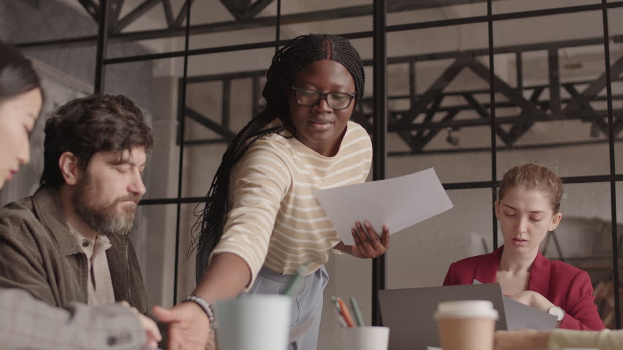 African Woman Handing in Papers